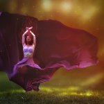 A person in a flowing purple dress is captured mid-dance, with arms raised above the head and the dress billowing dramatically around the body. The background is a blend of warm colors, creating a mystical and ethereal atmosphere.